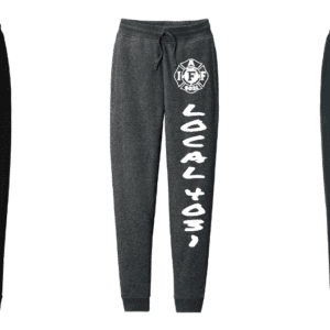 Black jogger pants with bold white Japanese text down the leg.